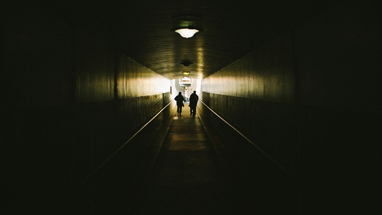 Photo of two persons at the end of a tunnel